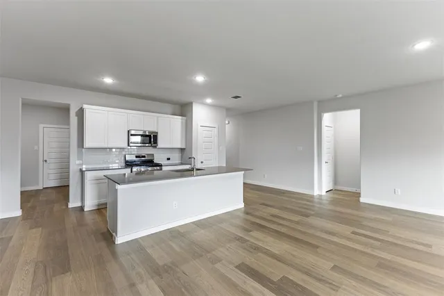 a view of kitchen with sink microwave and stove