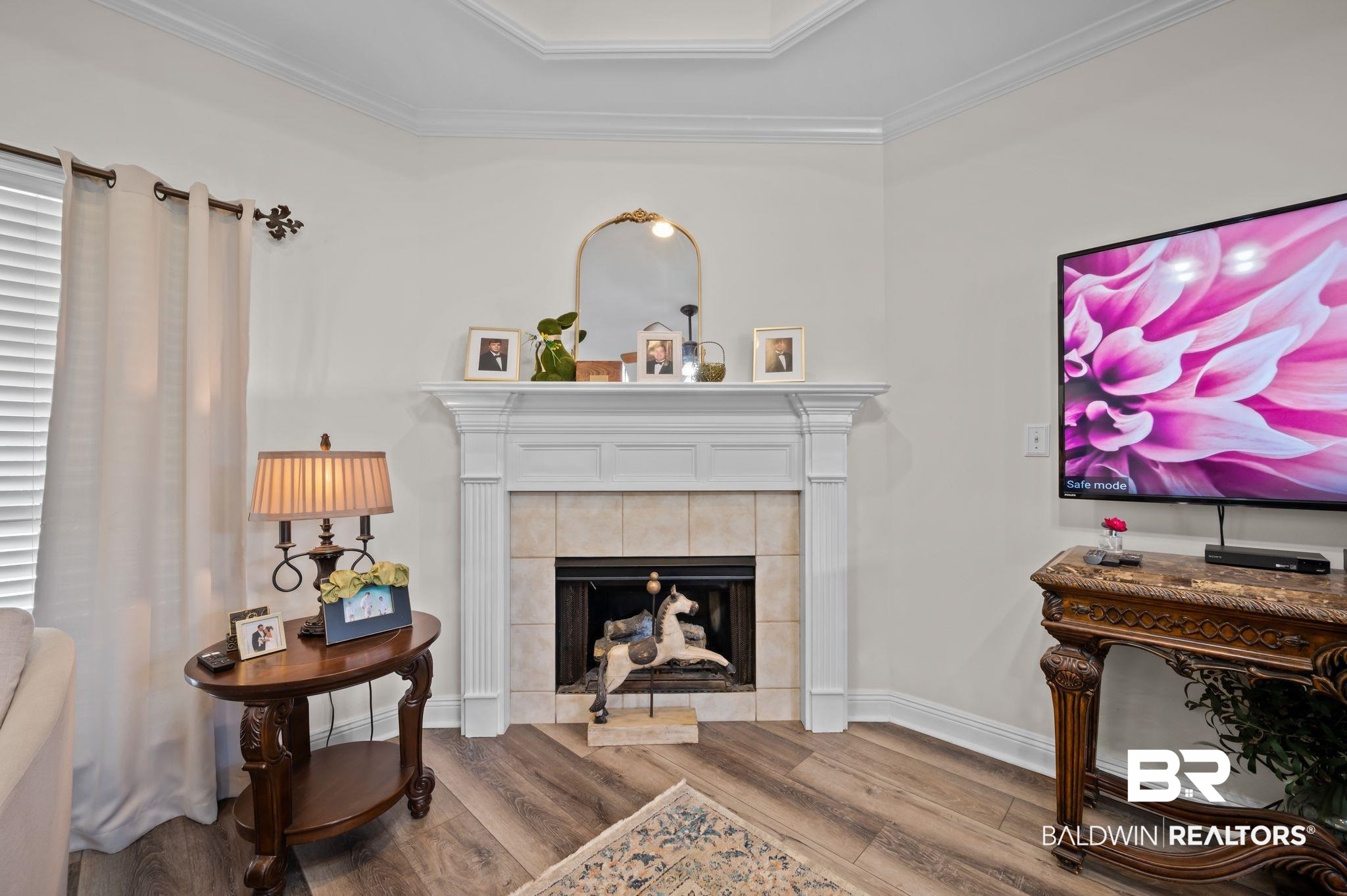 9837 Harmony Ridge Drive Semmes, AL 36575 - Photo 11 of 29 Sitting room with baseboards, crown molding, wood finished floors, and a tiled fireplace