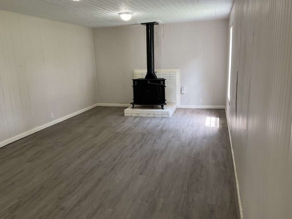 1329 Adams Road Bay City, TX 77414 - Photo 7 of 13 a view of an empty room with wooden floor and a window