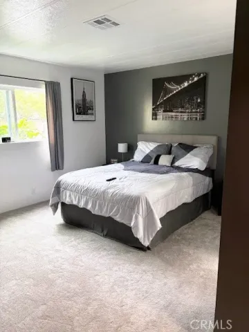 a bedroom with a bed and dresser