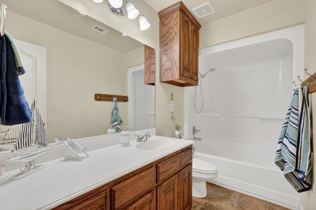 2828 Bennett Road Howe, TX 75459 - Photo 27 of 39 a bathroom with a sink a toilet and bathtub