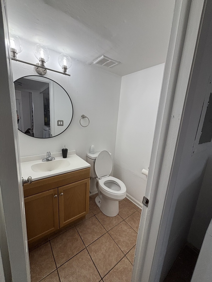 1707 Queensbury Circle Hoffman Estates, IL 60169 - Photo 2 of 10 a bathroom with a toilet sink and mirror