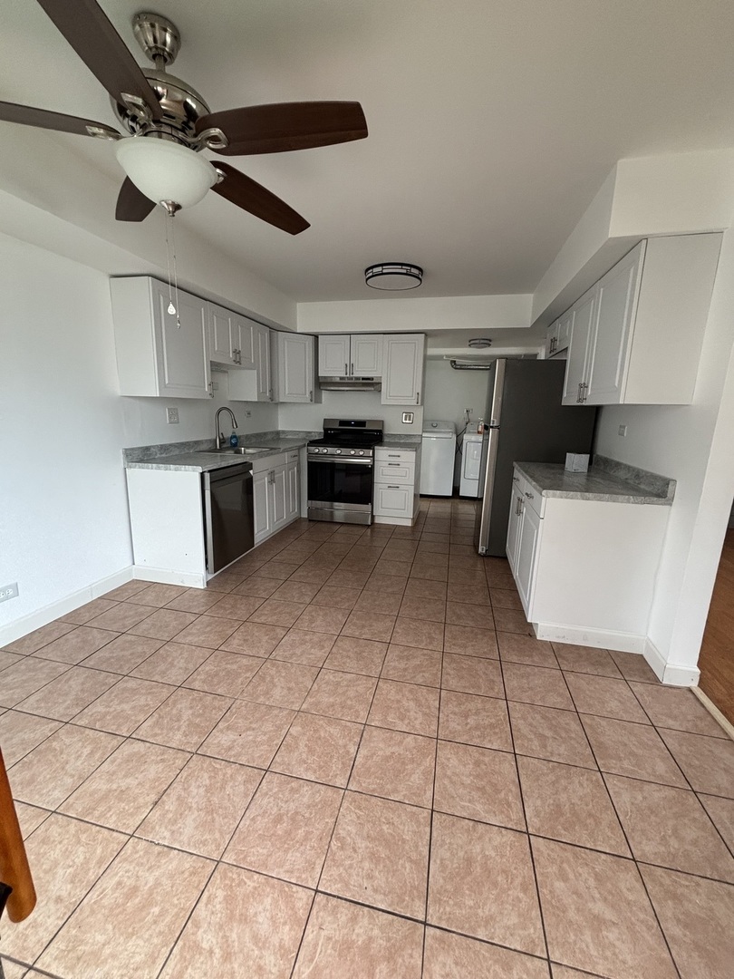 1707 Queensbury Circle Hoffman Estates, IL 60169 - Photo 4 of 10 a large white kitchen with a stove a sink and dishwasher