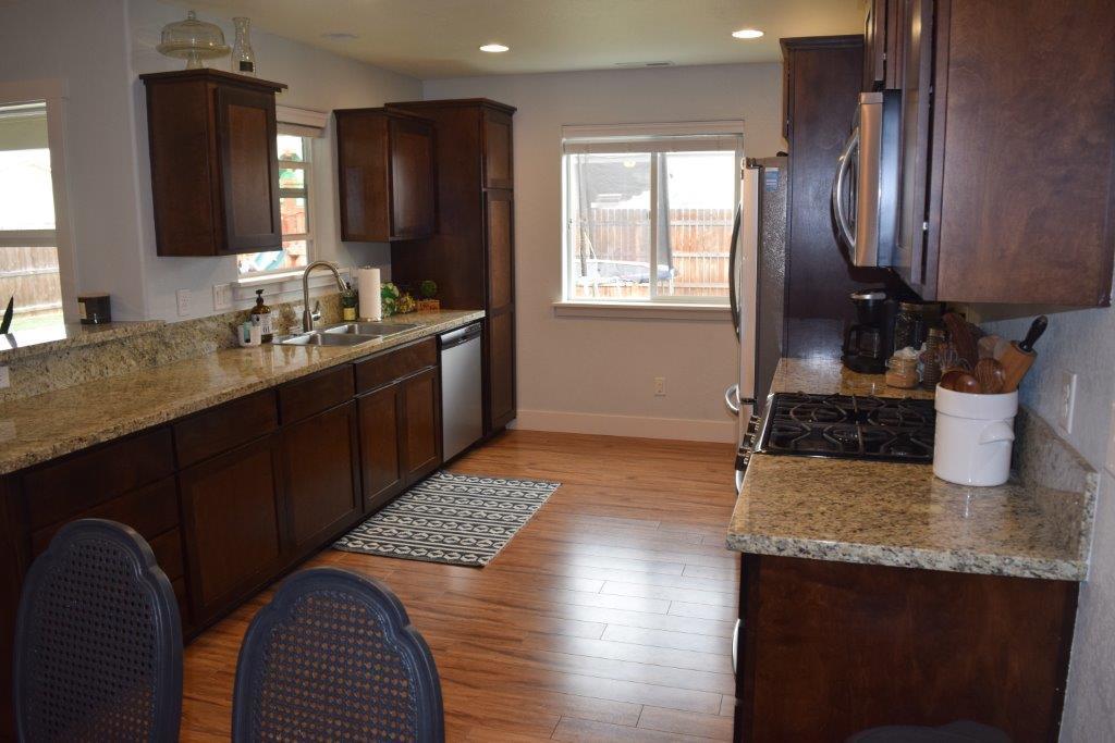 906 Win Way Eagle Point, OR 97524 - Photo 5 of 33 a kitchen with a sink stove and refrigerator