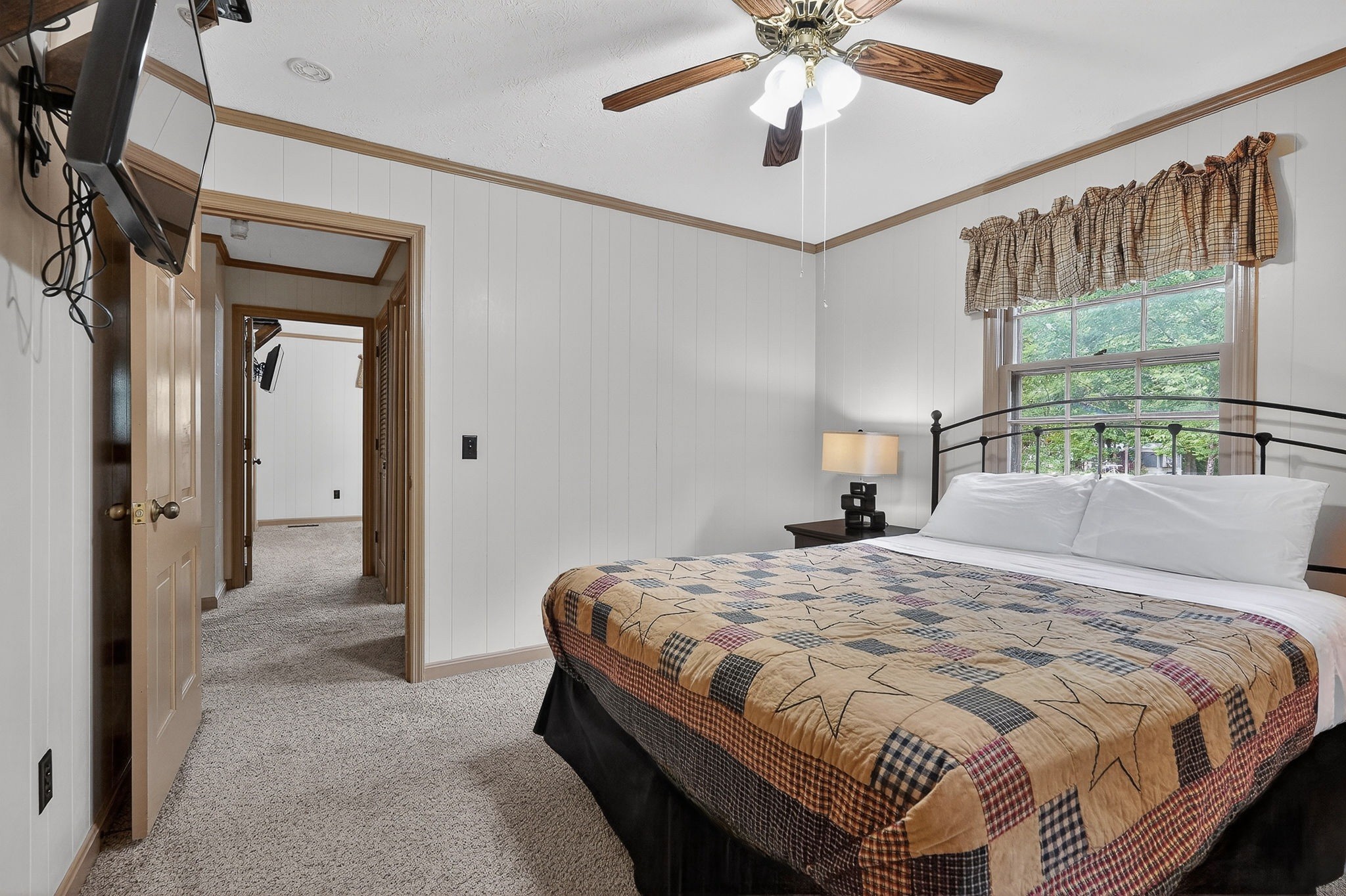 5642 Pates Ford Road Smithville, TN 37166 - Photo 18 of 32 a bedroom with a bed and a chandelier