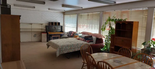 a kitchen with a refrigerator a stove cabinets and dining table
