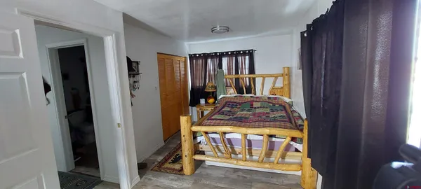 a bedroom with furniture and a window