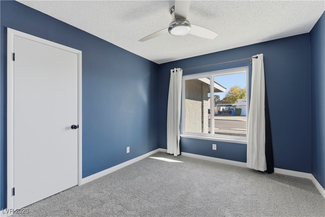 782 Darlene Way Boulder City, NV 89005 - Photo 20 of 39 Carpeted spare room with ceiling fan and a textured ceiling