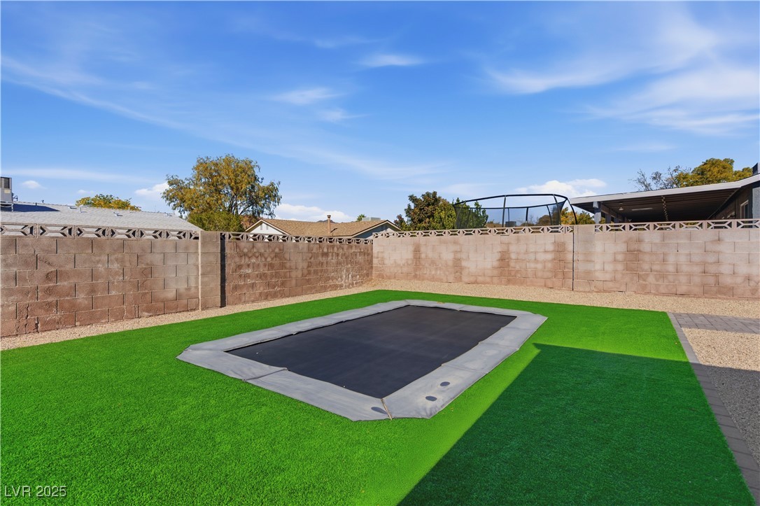 782 Darlene Way Boulder City, NV 89005 - Photo 28 of 39 View of fenced backyard with trampoline