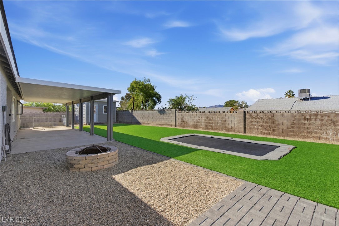782 Darlene Way Boulder City, NV 89005 - Photo 29 of 39 Fenced backyard with a patio area and an outdoor fire pit