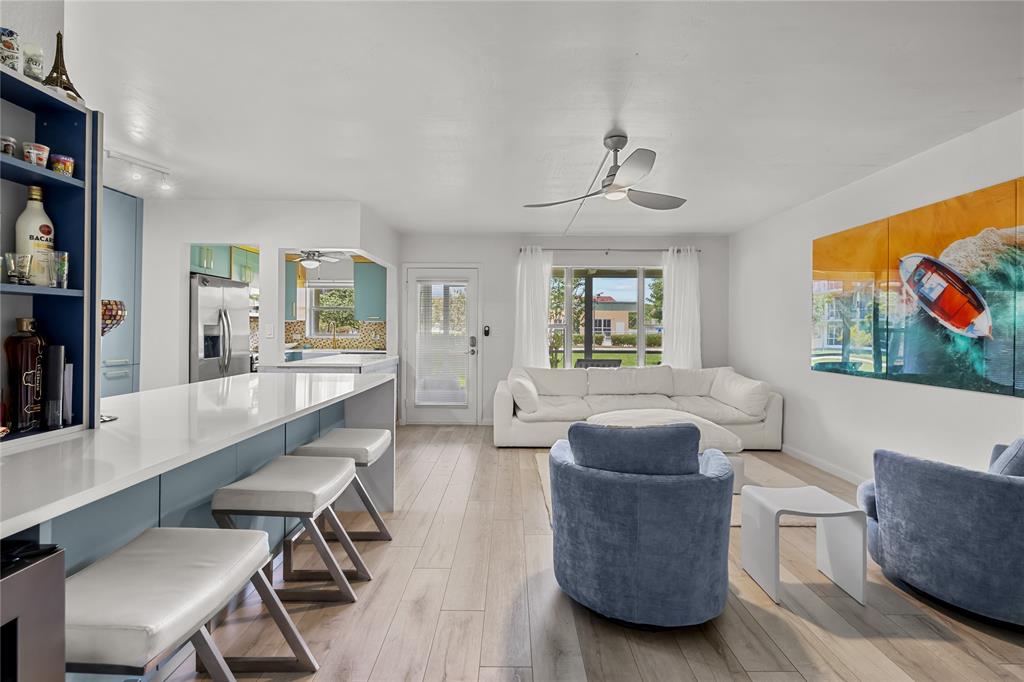 808 Southeast 7th Street, Unit 105B Deerfield Beach, FL 33441 - Photo 14 of 43 a living room with furniture and a flat screen tv