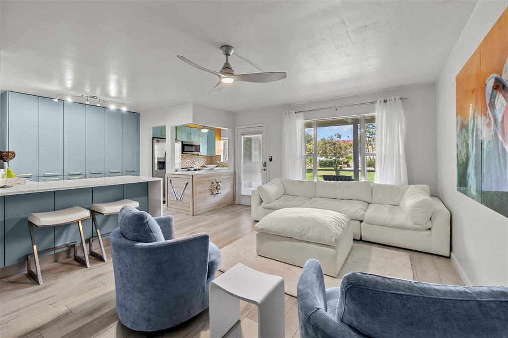 808 Southeast 7th Street, Unit 105B Deerfield Beach, FL 33441 - Photo 15 of 43 a living room with furniture and a large window