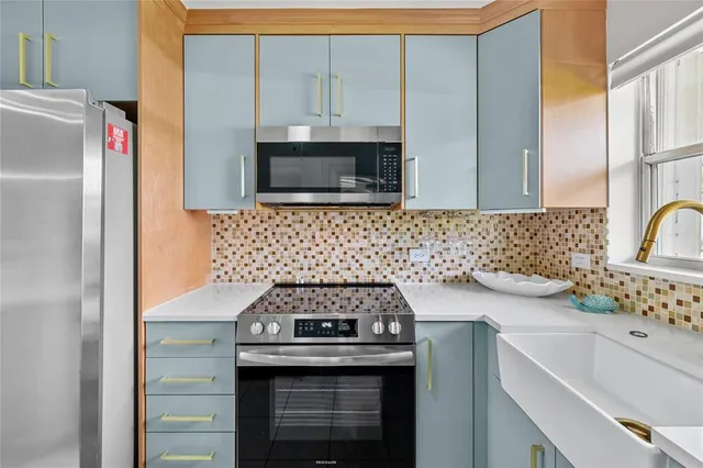 a kitchen with a sink stove and cabinets