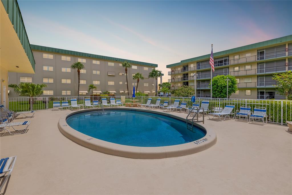 808 Southeast 7th Street, Unit 105B Deerfield Beach, FL 33441 - Photo 2 of 43 a swimming pool with outdoor seating and yard