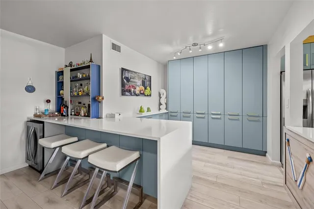 a kitchen with stainless steel appliances granite countertop a sink a stove and a refrigerator