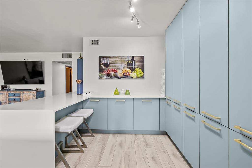 808 Southeast 7th Street, Unit 105B Deerfield Beach, FL 33441 - Photo 22 of 43 a hallway with a computer on a table and a flat screen tv