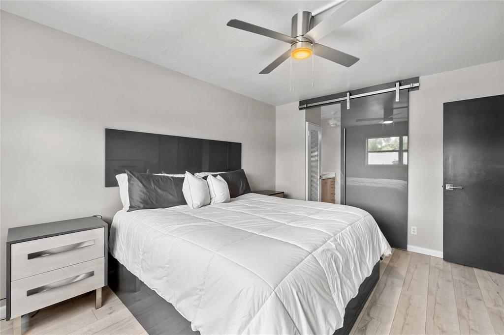 808 Southeast 7th Street, Unit 105B Deerfield Beach, FL 33441 - Photo 24 of 43 a bedroom with a bed and cabinet