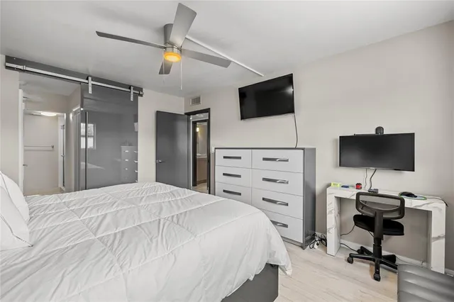 a bathroom with a sink a mirror toilet and shower