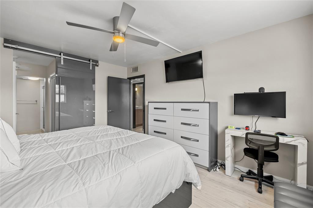 808 Southeast 7th Street, Unit 105B Deerfield Beach, FL 33441 - Photo 25 of 43 a bedroom with a bed and a flat screen tv