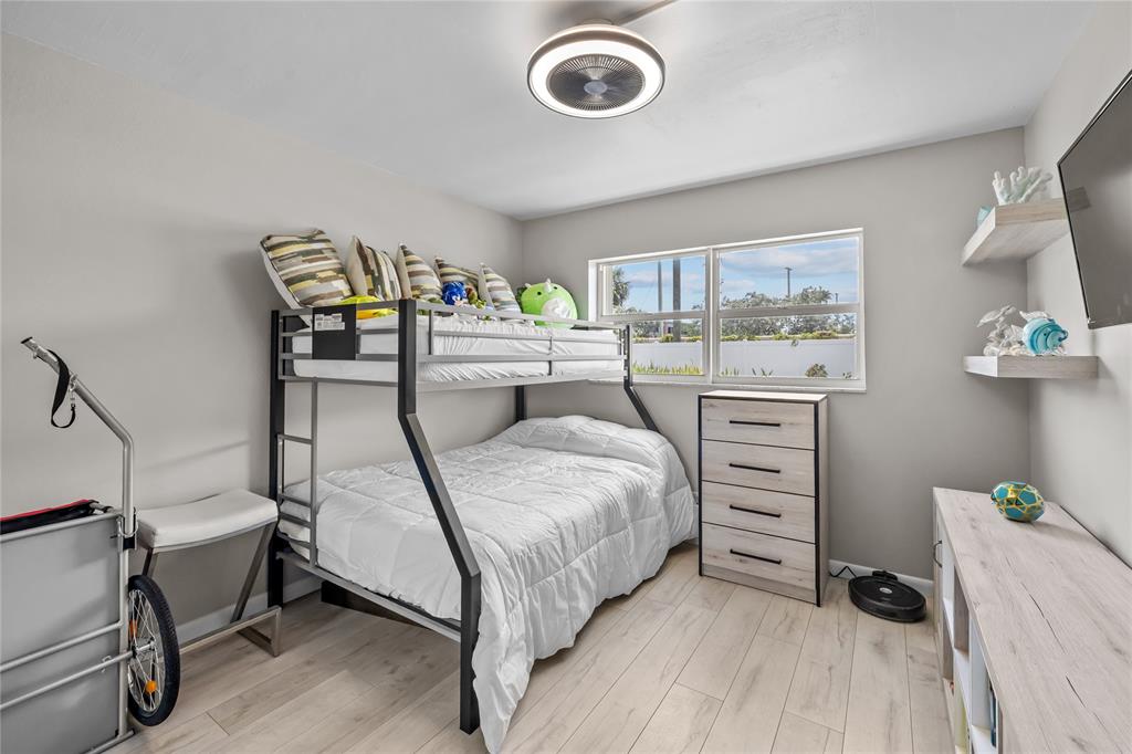 808 Southeast 7th Street, Unit 105B Deerfield Beach, FL 33441 - Photo 29 of 43 a bedroom with a bed and a dresser in it