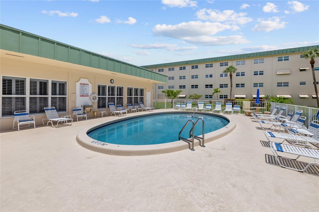808 Southeast 7th Street, Unit 105B Deerfield Beach, FL 33441 - Photo 35 of 43 a swimming pool with outdoor seating and yard