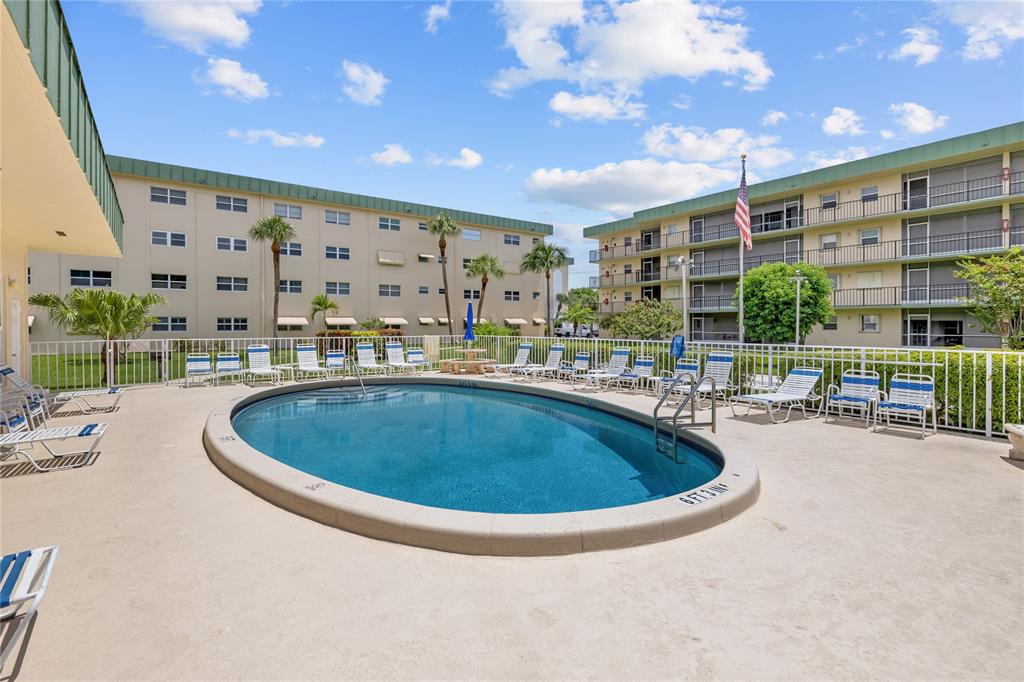 808 Southeast 7th Street, Unit 105B Deerfield Beach, FL 33441 - Photo 36 of 43 a swimming pool with outdoor seating and yard