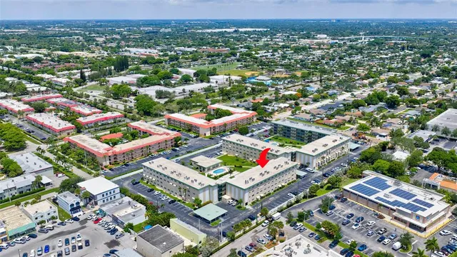 an aerial view of residential houses with outdoor space and street view
