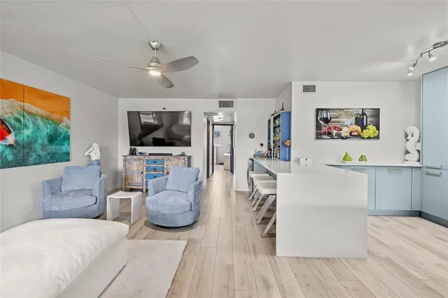 a view of living room with granite countertop furniture and flat screen tv