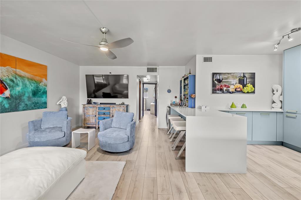 808 Southeast 7th Street, Unit 105B Deerfield Beach, FL 33441 - Photo 9 of 43 a living room with furniture and a flat screen tv