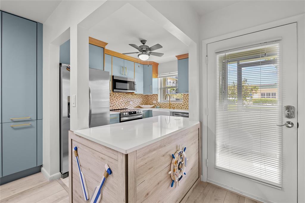 808 Southeast 7th Street, Unit 105B Deerfield Beach, FL 33441 - Photo 10 of 43 a kitchen with a sink stove and refrigerator