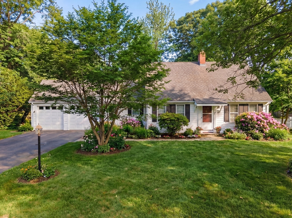 34 Cudworth Road Scituate, MA 02066 - Photo 3 of 3 a front view of a house with a garden and trees