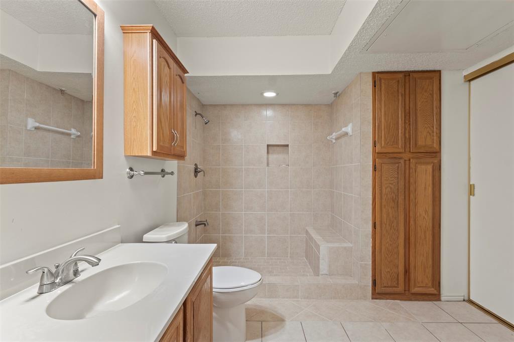 563 Ranch Trail, Unit 217 Irving, TX 75063 - Photo 15 of 19 a bathroom with a sink a toilet and shower