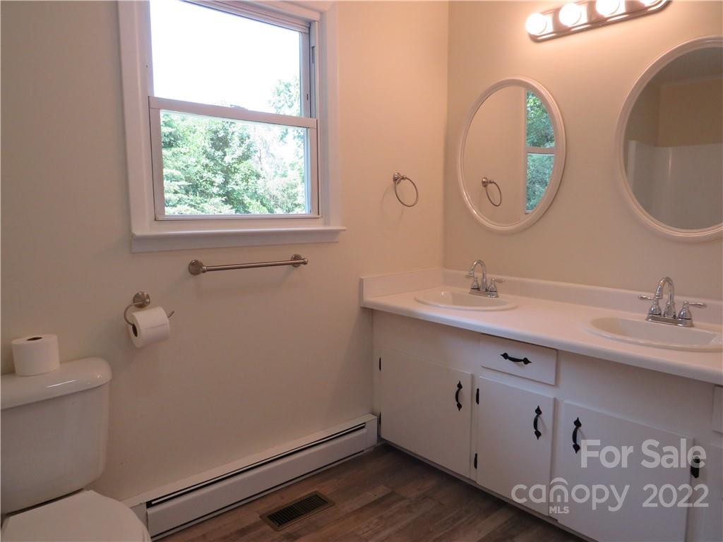 156 Eskimo Drive Bostic, NC 28018 - Photo 12 of 25 a bathroom with a toilet sink and mirror