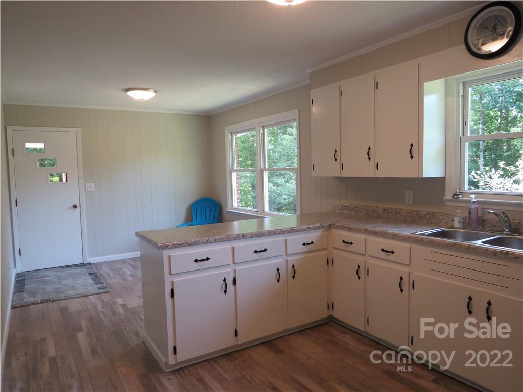 156 Eskimo Drive Bostic, NC 28018 - Photo 4 of 25 a kitchen with a sink cabinets wooden floor and a window