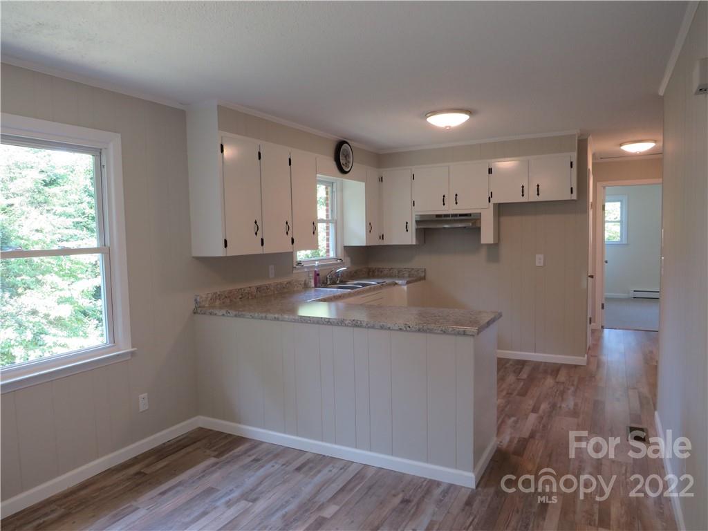 156 Eskimo Drive Bostic, NC 28018 - Photo 5 of 25 a kitchen with a sink window and cabinets