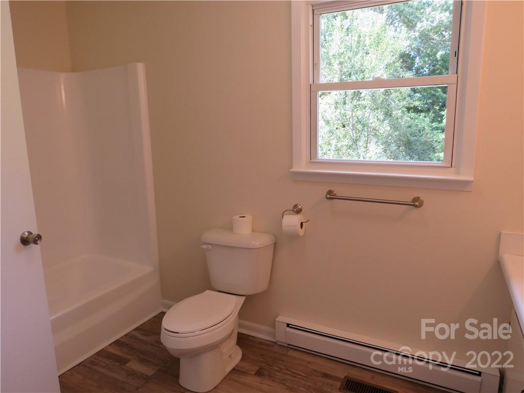156 Eskimo Drive Bostic, NC 28018 - Photo 9 of 25 a white toilet sitting next to a window