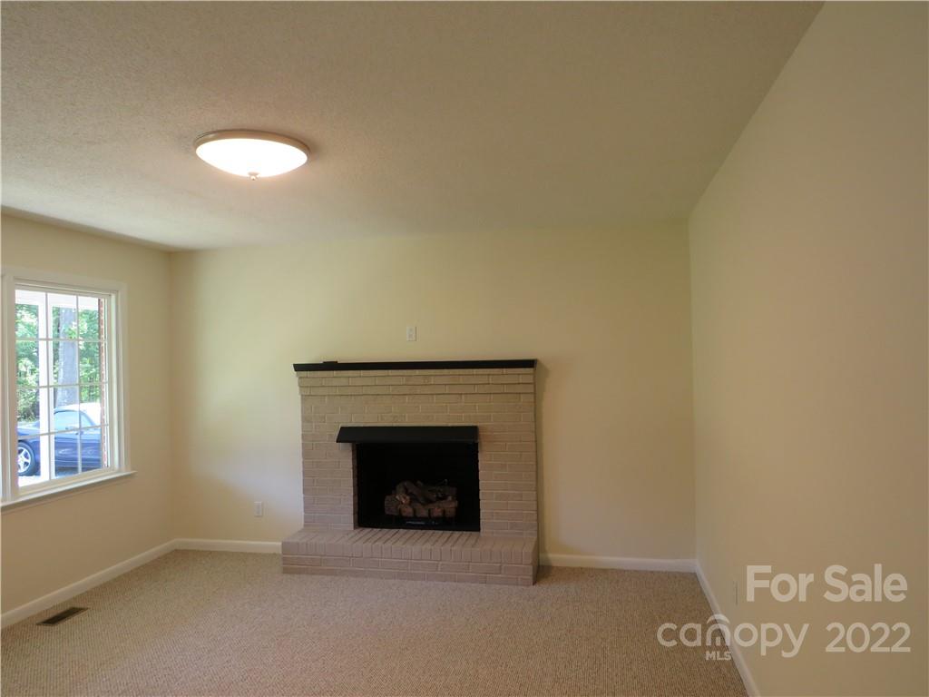 156 Eskimo Drive Bostic, NC 28018 - Photo 10 of 25 an empty room with a fireplace