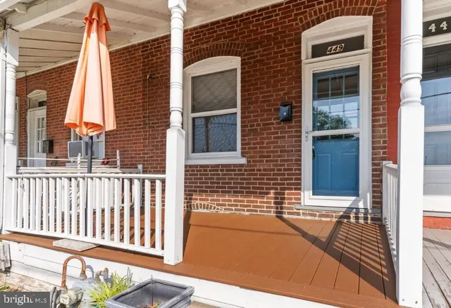 a view of a brick house with a large window