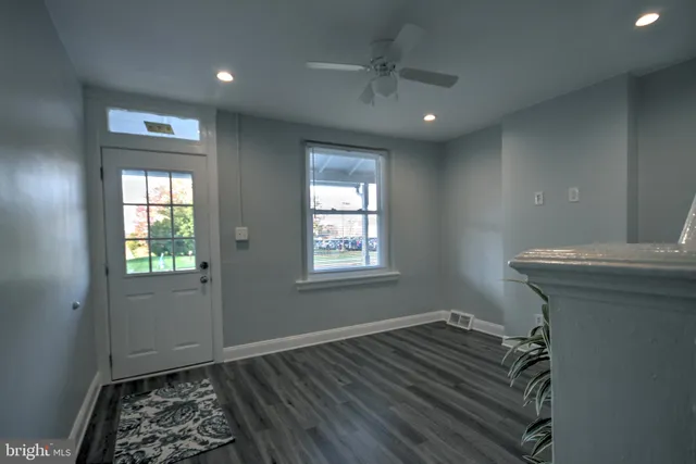 a view of entryway with window and wooden floor