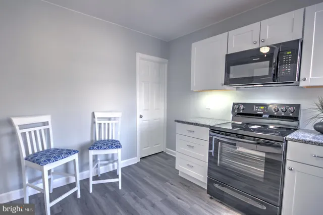 a kitchen with stainless steel appliances a stove microwave and cabinets