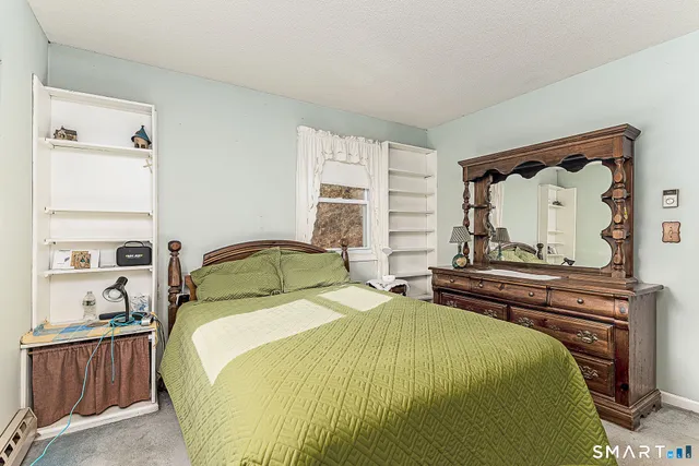 a bedroom with a bed and large window