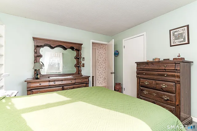 a bedroom with a bed and a dresser