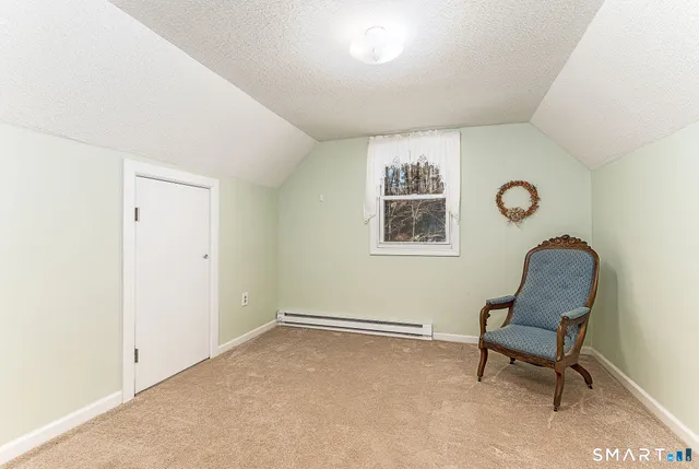 a view of a livingroom with furniture and a window