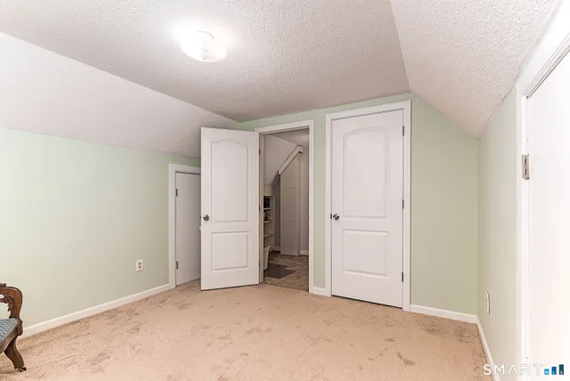 a bedroom with a bed a desk and chair