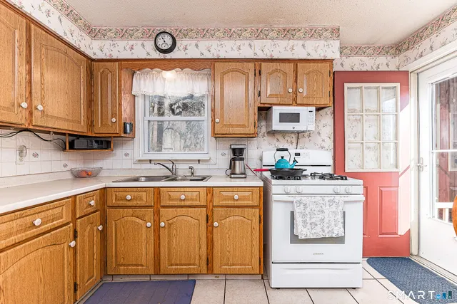 a kitchen with stainless steel appliances granite countertop a stove and cabinets