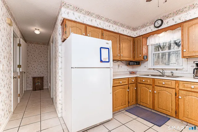 a kitchen with a refrigerator a sink and cabinets