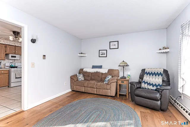 a living room with furniture and a wooden floor