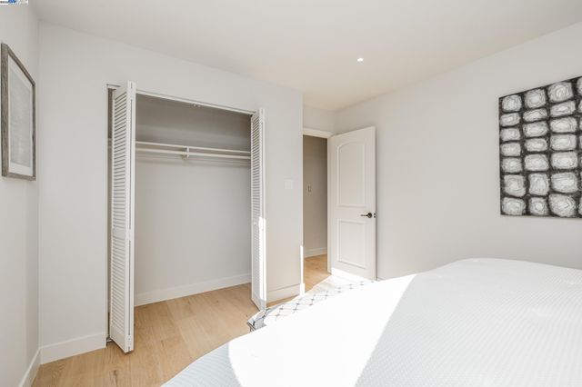 a bedroom with a bed and a wall painting