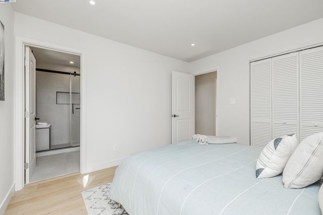 a bedroom with a bed and a walk in closet