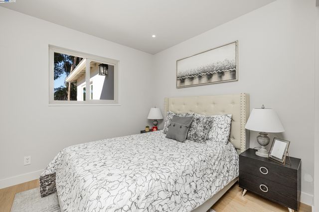 a bedroom with a bed and lamp on dresser